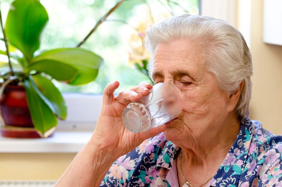 Idosa se refresca bebendo água. Foto: Divulgação